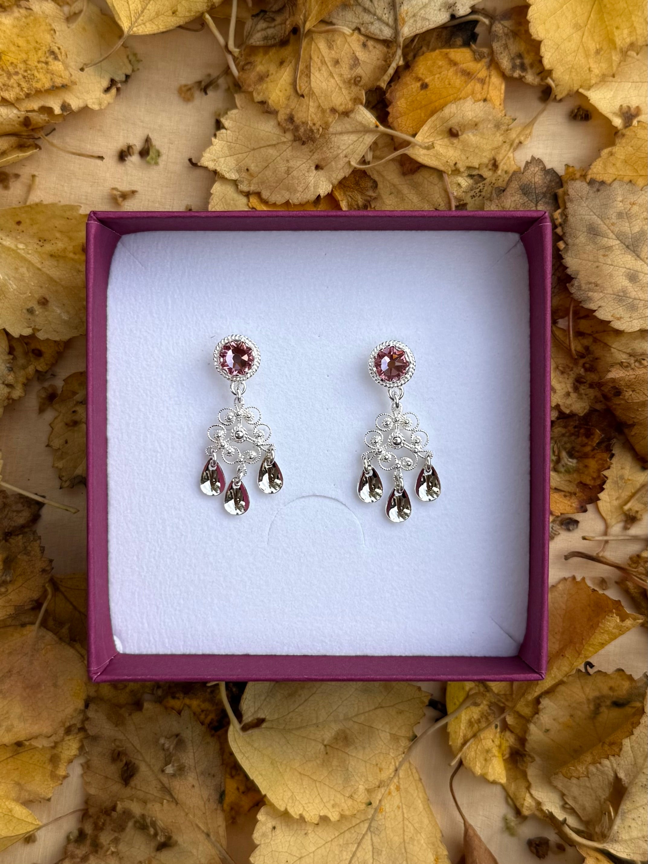 Ørepynt med lyserosa krystall